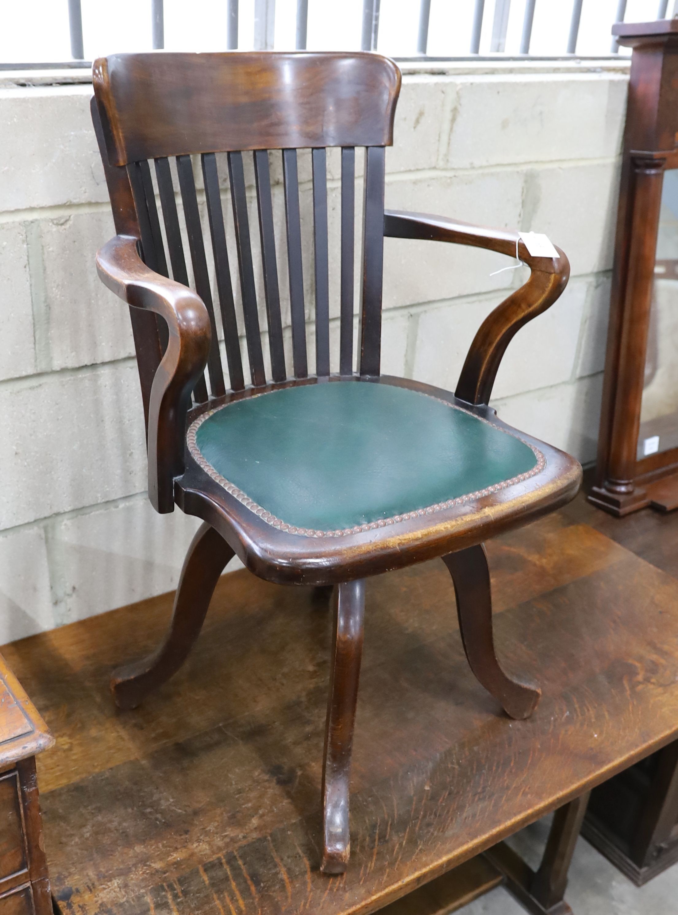 A 20th century beech swivel desk chair